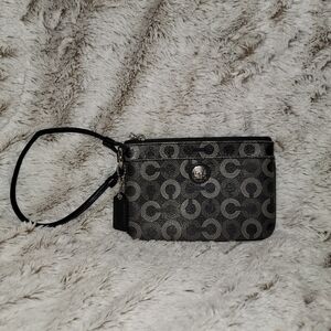 Coach wristlet in black and gray. Purple silk lining.